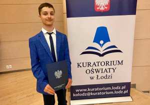 Na zdjęciu Arkadiusz w Auli Wydziału Prawa i Administracji Uniwersytetu Łódzkiego podczas wręczania nagród dla laureatów Wojewódzkiego Konkursu Historycznego.